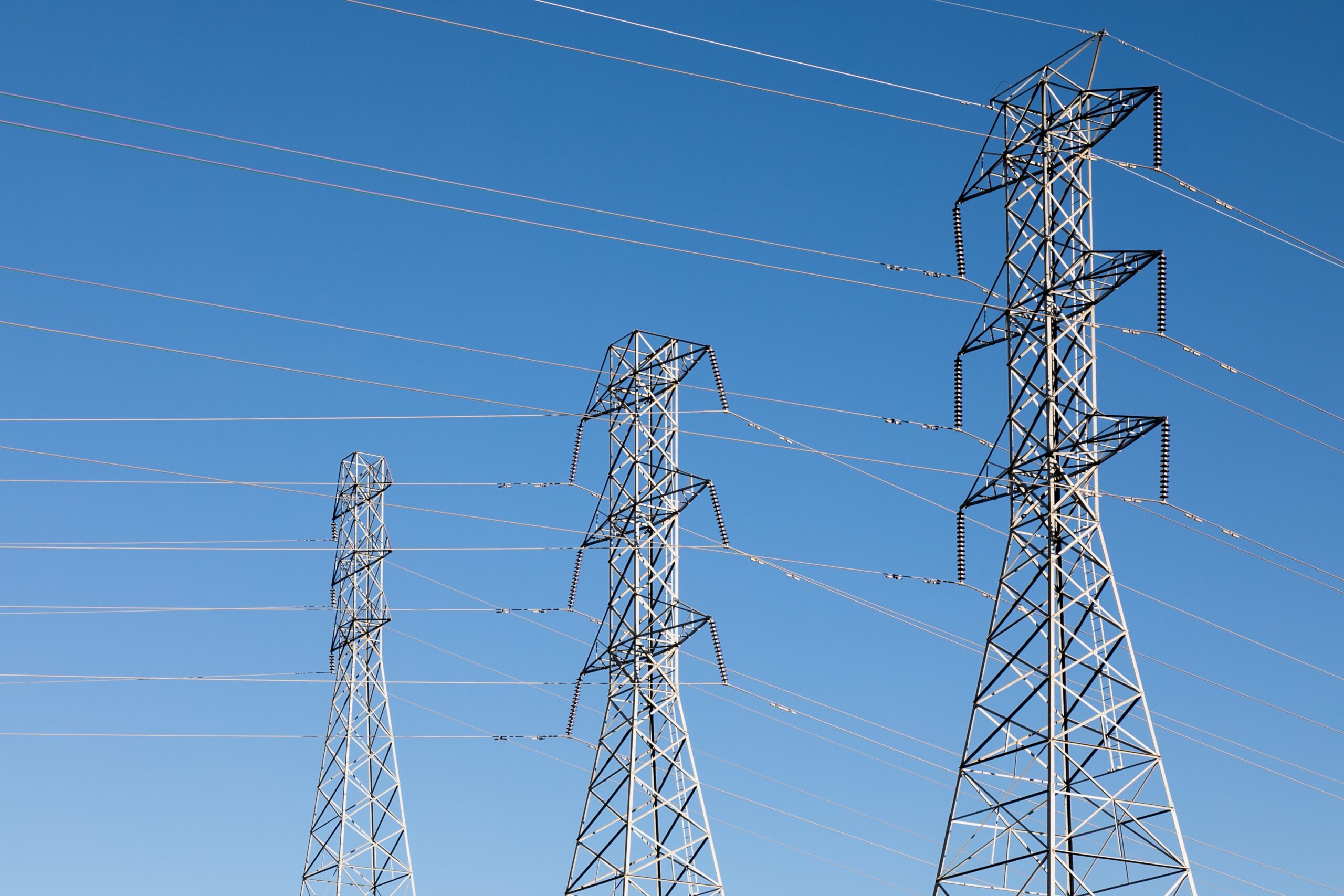 beautiful shot of electric poles under a blue sky